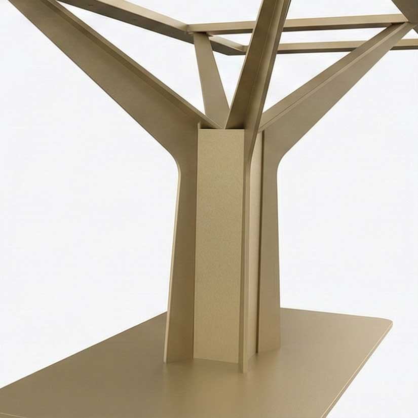 Beige metal table base with a central column and Y-shaped supports extending outward for stability, shown from a side angle.