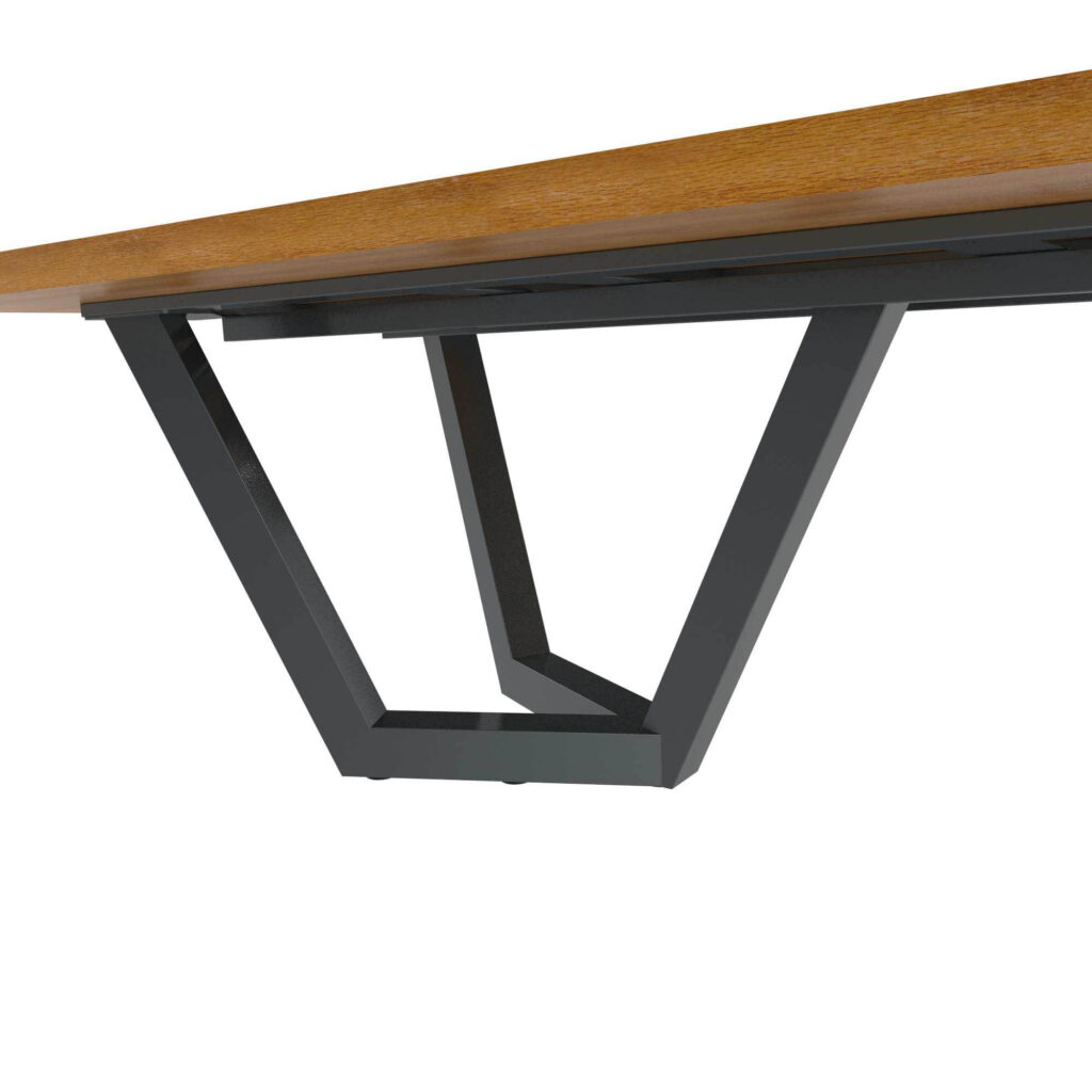 Close-up of a wooden tabletop edge resting on black metal angular legs forming a modern desk frame