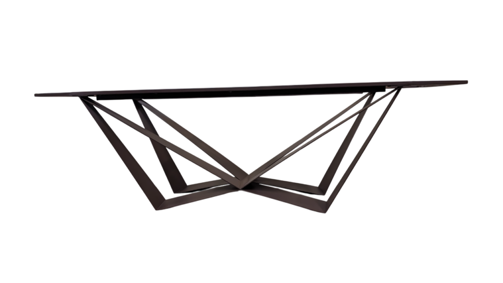 Modern console table with a geometric, angular black metal base on a black background, top is slim and rectangular.
